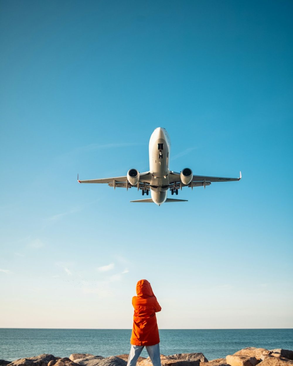 woman filming plane landing on phone woman filming plane landing on phone